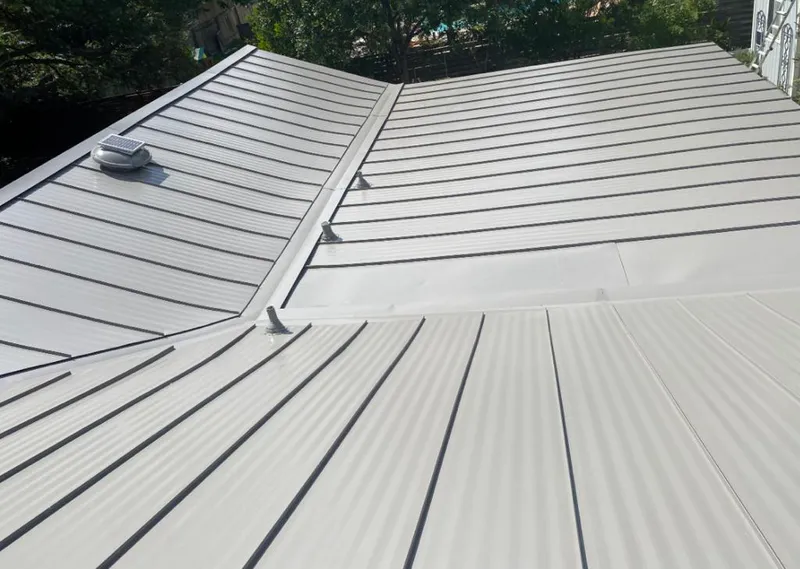 Solar attic fan installed on a metal roof for Roof Ventilation in Lake Lorraine