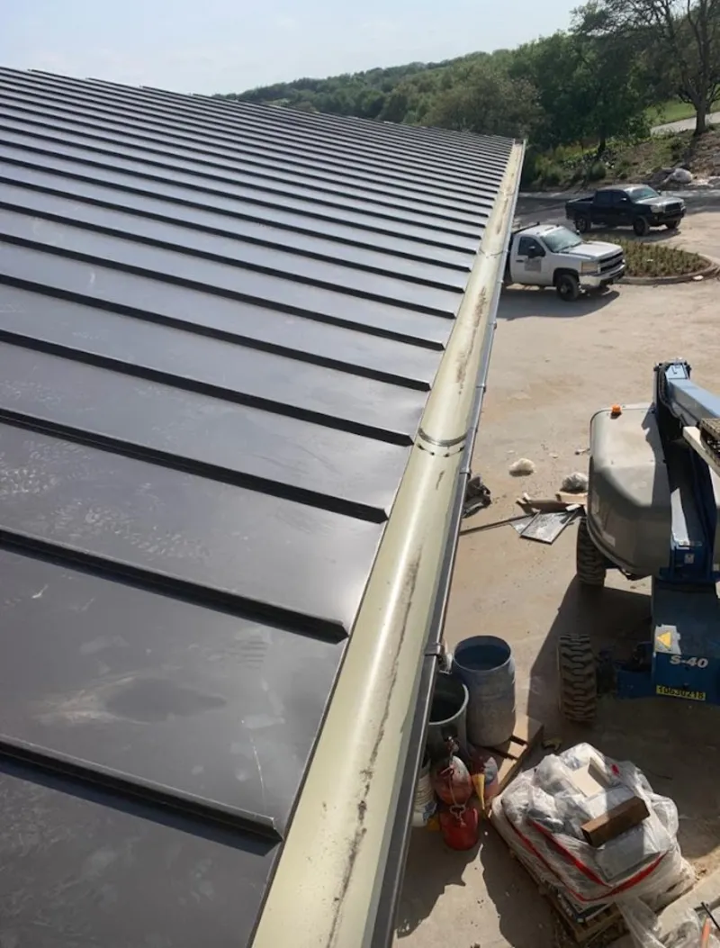 Standing seam panel and gutter detail on a metal roofing jobsite in Lake Lorraine